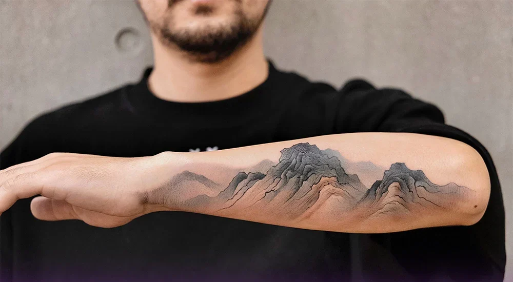 A boy with tattoos on his hand and elbow