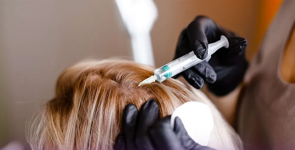 A doctor performing hair botox on another woman
