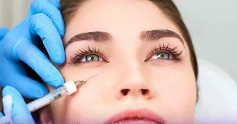 A woman who sleeps up and looks up and the doctor's hands are injecting Botox under her eyes