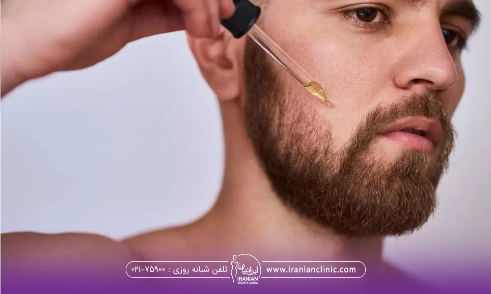 مردی که محلولی را با قطره چکان روی ریش خود می ریزد تا رشد ریش و سبیل را تقویت کند