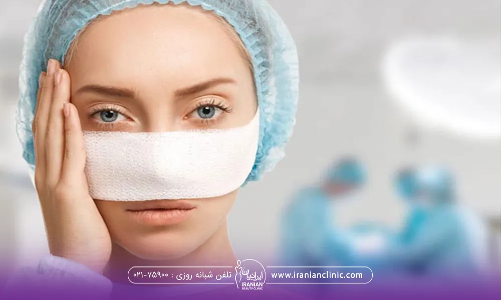 دختری که عمل بینی انجام داده است و بینی خود را باند پیچی کرده و دست خود را کنار صورتش گذاشته است - عوارض عمل بینی