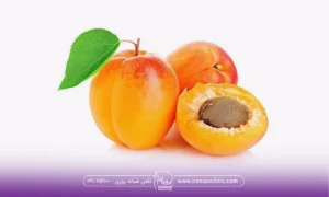 یک زردآلو نصف و دو تا زردالو کامل کنار هم قرار گرفته اند - خواص زردآلو برای پوست